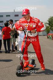 15.07.2006 Magny Cours, France,  Michael Schumacher (GER), Scuderia Ferrari on his scooter - Formula 1 World Championship, Rd 11, French Grand Prix, Saturday