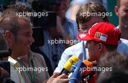 15.07.2006 Magny Cours, France,  Michael Schumacher (GER), Scuderia Ferrari, talking with Kai Ebel (GER), RTL Television - Formula 1 World Championship, Rd 11, French Grand Prix, Saturday Qualifying