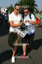 15.07.2006 Magny Cours, France,  Michael Schumacher (GER), Scuderia Ferrari, Portrait, signing autographs - Formula 1 World Championship, Rd 11, French Grand Prix, Saturday