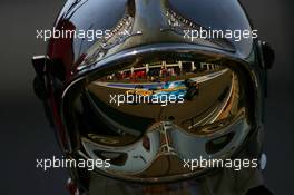 15.07.2006 Magny Cours, France,  Fernando Alonso (ESP), Renault F1 Team, R26, Reflection in a Fire Marshalls helmet - Formula 1 World Championship, Rd 11, French Grand Prix, Saturday Practice