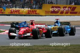 15.07.2006 Magny Cours, France,  Michael Schumacher (GER), Scuderia Ferrari 248 F1 and Fernando Alonso (ESP), Renault F1 Team R26, fighting for position during qualifying - Formula 1 World Championship, Rd 11, French Grand Prix, Saturday Qualifying