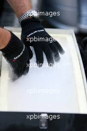 16.07.2006 Magny Cours, France,  McLaren mechanic preparing dry ice for the cooling of the cars on the grid - Formula 1 World Championship, Rd 11, French Grand Prix, Sunday