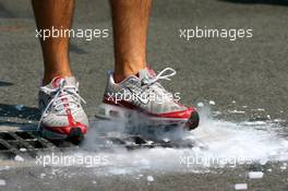 16.07.2006 Magny Cours, France,  Toyota mechanic dumping dry ice - Formula 1 World Championship, Rd 11, French Grand Prix, Sunday