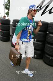 13.07.2006 Magny Cours, France,  Jarno Trulli (ITA), Toyota Racing, Portrait, coming into the paddock with an Italian flag around him and a football World Champion T-shirt - Formula 1 World Championship, Rd 11, French Grand Prix, Thursday