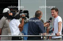 13.07.2006 Magny Cours, France,  David Coulthard (GBR), Red Bull Racing, Portrait, being interviewed for TV - Formula 1 World Championship, Rd 11, French Grand Prix, Thursday