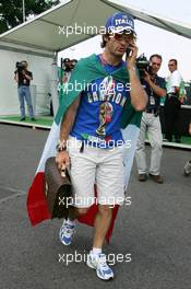 13.07.2006 Magny Cours, France,  Jarno Trulli (ITA), Toyota Racing, Portrait, coming into the paddock with an Italian flag around him and a football World Champion T-shirt - Formula 1 World Championship, Rd 11, French Grand Prix, Thursday