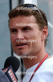 13.07.2006 Magny Cours, France,  David Coulthard (GBR), Red Bull Racing, Portrait, being interviewed for TV - Formula 1 World Championship, Rd 11, French Grand Prix, Thursday