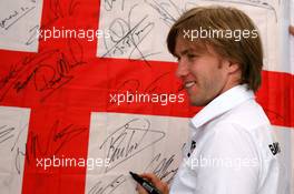 09.06.2006 Silverstone, England,  Nick Heidfeld (GER), BMW Sauber F1 Team signs an England flag - Formula 1 World Championship, Rd 8, British Grand Prix, Friday