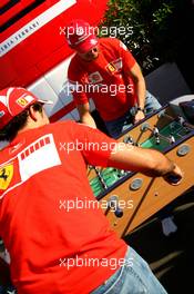 10.06.2006 Silverstone, England,  Michael Schumacher (GER), Scuderia Ferrari and Felipe Massa (BRA), Scuderia Ferrari play table football in the paddock - Formula 1 World Championship, Rd 8, British Grand Prix, Saturday