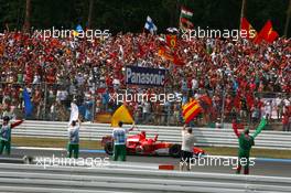 30.07.2006 Hockenheim, Germany,  Fans and marshalls greeting race winner Michael Schumacher (GER), Scuderia Ferrari 248 F1 - Formula 1 World Championship, Rd 12, German Grand Prix, Sunday Podium