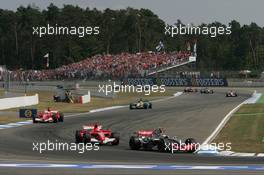 30.07.2006 Hockenheim, Germany,  Kimi Raikkonen (FIN), Räikkönen, McLaren Mercedes, MP4-21 leads Michael Schumacher (GER), Scuderia Ferrari, 248 F1 at the start of the race - Formula 1 World Championship, Rd 12, German Grand Prix, Sunday Race