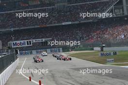 30.07.2006 Hockenheim, Germany,  Start, Kimi Raikkonen (FIN), Räikkönen, McLaren Mercedes, MP4-21, Michael Schumacher (GER), Scuderia Ferrari, 248 F1, Felipe Massa (BRA), Scuderia Ferrari, 248 F1 - Formula 1 World Championship, Rd 12, German Grand Prix, Sunday Race