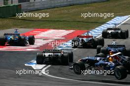 30.07.2006 Hockenheim, Germany,  Jenson Button (GBR), Honda Racing F1 Team RA106 and Pedro de la Rosa (ESP), Team McLaren Mercedes MP4-21, overtake Fernando Alonso (ESP), Renault F1 Team R26 at the hairpin and force him to go wide. In the corner of the picture, David Coulthard (GBR), Red Bull Racing RB2, is flying through the air - Formula 1 World Championship, Rd 12, German Grand Prix, Sunday Race