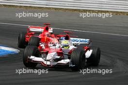 30.07.2006 Hockenheim, Germany,  Michael Schumacher (GER), Scuderia Ferrari 248 F1, while leading the race, allows his brother Ralf Schumacher (GER), Toyota Racing TF106, to unlap himself - Formula 1 World Championship, Rd 12, German Grand Prix, Sunday Race