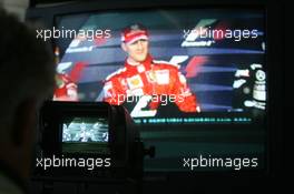 30.07.2006 Hockenheim, Germany,  Michael Schumacher (GER), Scuderia Ferrari in the press conference on a tv monitor - Formula 1 World Championship, Rd 12, German Grand Prix, Sunday Race