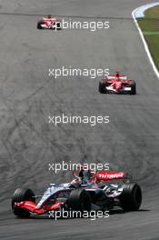 30.07.2006 Hockenheim, Germany,  Kimi Raikkonen (FIN), Team West McLaren Mercedes MP4-21, leads Michael Schumacher (GER), Scuderia Ferrari 248 F1 and Felipe Massa (BRA), Scuderia Ferrari 248 F1 - Formula 1 World Championship, Rd 12, German Grand Prix, Sunday Race