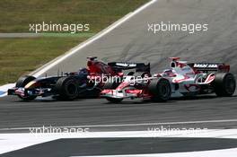 30.07.2006 Hockenheim, Germany,  Scott Speed (USA), Scuderia Toro Rosso STR 01 and Takuma Sato (JPN), Super Aguri F1 SA06, fighting for position - Formula 1 World Championship, Rd 12, German Grand Prix, Sunday Race