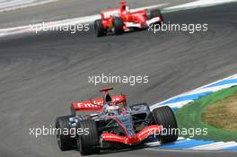 30.07.2006 Hockenheim, Germany,  Kimi Raikkonen (FIN), Räikkönen, McLaren Mercedes, MP4-21 and Michael Schumacher (GER), Scuderia Ferrari, 248 F1  - Formula 1 World Championship, Rd 12, German Grand Prix, Sunday Race