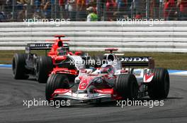 30.07.2006 Hockenheim, Germany,  Takuma Sato (JPN), Super Aguri F1 SA06, leads Tiago Monteiro (POR), Midland F1 Racing M16 - Formula 1 World Championship, Rd 12, German Grand Prix, Sunday Race