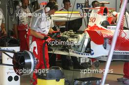 29.07.2006 Hockenheim, Germany,  Toyota F1 Mechanics clean up the mess made by putting out the fire on Jarno Trulli's (ITA), Toyota Racing, TF106 - Formula 1 World Championship, Rd 12, German Grand Prix, Saturday Practice