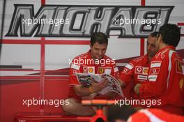 29.07.2006 Hockenheim, Germany,  Scuderia Ferrari, Mechanics read the Red Bulletin - Formula 1 World Championship, Rd 12, German Grand Prix, Saturday