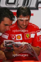 29.07.2006 Hockenheim, Germany,  Scuderia Ferrari mechanics read the Red Bulletin - Formula 1 World Championship, Rd 12, German Grand Prix, Saturday