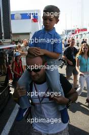 30.07.2006 Hockenheim, Germany,  Rubens Barrichello (BRA), Honda Racing F1 Team arrives with a kid on his shoulders - Formula 1 World Championship, Rd 12, German Grand Prix, Sunday
