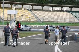 27.07.2006 Hockenheim, Germany,  Tiago Monteiro (POR), Midland MF1 Racing and Midland MF1 Racing team personnel, go to walk a lap of the circuit - Formula 1 World Championship, Rd 12, German Grand Prix, Thursday