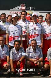 27.07.2006 Hockenheim, Germany,  Ralf Schumacher (GER), Toyota Racing and Jarno Trulli (ITA), Toyota Racing, with team personnel and the team bus - Formula 1 World Championship, Rd 12, German Grand Prix, Thursday