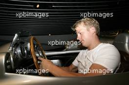 26.07.2006 Stuttgart, Germany,  Kimi Raikkonen (FIN), Räikkönen, McLaren Mercedesstand sits in a historical silver arrow at the Mercedes-Benz branch in Stuttgart. - DaimlerChrysler / Mercedes Media warm up - Formula 1 World Championship, Rd 12, German Grand Prix, Wednesday