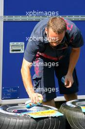 26.07.2006 Hockenheim, Germany,  Torro Rosso mechanic marking the tyres - Formula 1 World Championship, Rd 12, German Grand Prix, Wednesday