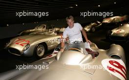 26.07.2006 Stuttgart, Germany,  Kimi Raikkonen (FIN), Räikkönen, McLaren Mercedesstand sits in a historical silver arrow at the Mercedes-Benz branch in Stuttgart. - DaimlerChrysler / Mercedes Media warm up - Formula 1 World Championship, Rd 12, German Grand Prix, Wednesday