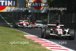 10.09.2006 Monza, Italy,  Rubens Barrichello (BRA), Honda Racing F1 Team, RA106 and Jarno Trulli (ITA), Toyota Racing, TF106 - Formula 1 World Championship, Rd 15, Italian Grand Prix, Sunday Race