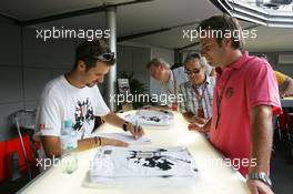07.09.2006 Monza, Italy,  Tiago Monteiro (POR), Midland MF1 Racing, signs his Monza edition T-shirt - Formula 1 World Championship, Rd 15, Italian Grand Prix, Thursday