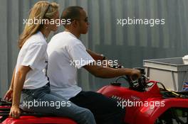 07.09.2006 Monza, Italy,  Lewis Hamilton (GBR), ART Grand Prix, gives a girl a ride on his quad bike - Formula 1 World Championship, Rd 15, Italian Grand Prix, Thursday