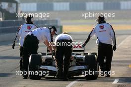 07.02.2006 Jerez, Spain,  Jenson Button (GBR), Honda Racing F1 Team, car is taken back to the garage after stopping at the pit exit