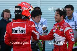 07.10.2006 Suzuka, Japan,  Michael Schumacher (GER), Scuderia Ferrari congratulates Felipe Massa's pole position - Formula 1 World Championship, Rd 17, Japanese Grand Prix, Saturday Qualifying
