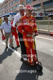 27.05.2006 Monte Carlo, Monaco,  Michael Schumacher (GER), Scuderia Ferrari and Willi Weber (GER), Driver Manager on the back of a electro scooter on the way to the pit lane - Formula 1 World Championship, Rd 7, Monaco Grand Prix, Saturday