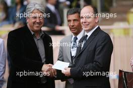 23.05.2006 Monte Carlo, Monaco,  Prince Albert II of Monaco gives a cheque to the charity supporting the football match - Formula 1 World Championship, Rd 7, Monaco Grand Prix, Wednesday