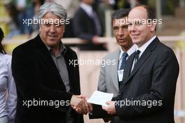 23.05.2006 Monte Carlo, Monaco,  Prince Albert II of Monaco gives a cheque to the charity supporting the football match - Formula 1 World Championship, Rd 7, Monaco Grand Prix, Wednesday