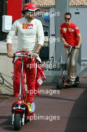 25.05.2006 Monte Carlo, Monaco,  Felipe Massa (BRA), Scuderia Ferrari and Michael Schumacher (GER), Scuderia Ferrari on electro scooters - Formula 1 World Championship, Rd 7, Monaco Grand Prix, Thursday