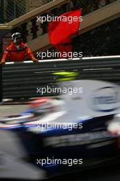 25.05.2006 Monte Carlo, Monaco,  Robert Kubica (POL), Test Driver, BMW Sauber F1 Team drives past marshalls waving the red flag after an incident on track - Formula 1 World Championship, Rd 7, Monaco Grand Prix, Thursday