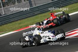 27.08.2006 Istanbul, Turkey,  Nick Heidfeld (GER), BMW Sauber F1 Team, F1.06 leads Christijan Albers (NED), Midland MF1 Racing, Toyota M16 - Formula 1 World Championship, Rd 14, Turkish Grand Prix, Sunday Race