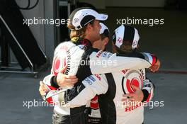 24.08.2006 Istanbul, Turkey,  Jenson Button (GBR), Honda Racing F1 Team has a hug with team mates Anthony Davidson (GBR), Test Driver, Honda Racing F1 Team and Rubens Barrichello (BRA), Honda Racing F1 Team - Formula 1 World Championship, Rd 14, Turkish Grand Prix, Thursday