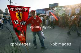 23.08.2006 Istanbul, Turkey,  A Ferrari fan stands in front of an advertising banner in downtown Istanbul - Formula 1 World Championship, Rd 14, Turkish Grand Prix, Wednesday