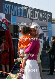 23.08.2006 Istanbul, Turkey,  A woman wearing a scarf stands in front of an advertising banner in downtown Istanbul - Formula 1 World Championship, Rd 14, Turkish Grand Prix, Wednesday