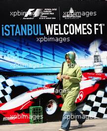 23.08.2006 Istanbul, Turkey,  A woman with a scarf walks in front of an advertising banner in downtown Istanbul - Formula 1 World Championship, Rd 14, Turkish Grand Prix, Wednesday