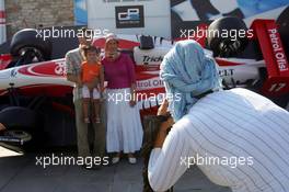 23.08.2006 Istanbul, Turkey,  A woman wearing a scarf photographs a family in front of a GP2 Racing car in downtown Istanbul - Formula 1 World Championship, Rd 14, Turkish Grand Prix, Wednesday