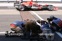 30.06.2006 Indianapolis, USA,  Photographers taking photos of the cars passing over Indianapolis famous bricks - Formula 1 World Championship, Rd 10, United States Grand Prix, Friday Practice