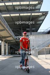 29.06.2006 Indianapolis, USA,  Michael Schumacher (GER), Scuderia Ferrari on his scooter in front of the IMS tower - Formula 1 World Championship, Rd 10, United States Grand Prix, Thursday